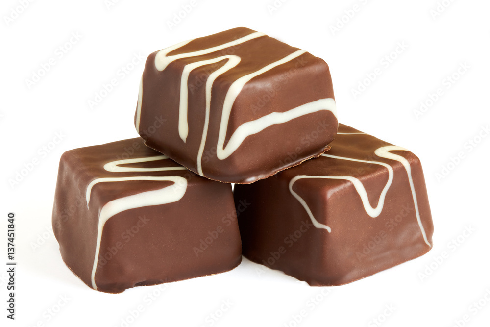 Small chocolate cakes (mignon) with cream isolated on white background Small chocolate cakes (mignon) with cream isolated on white background