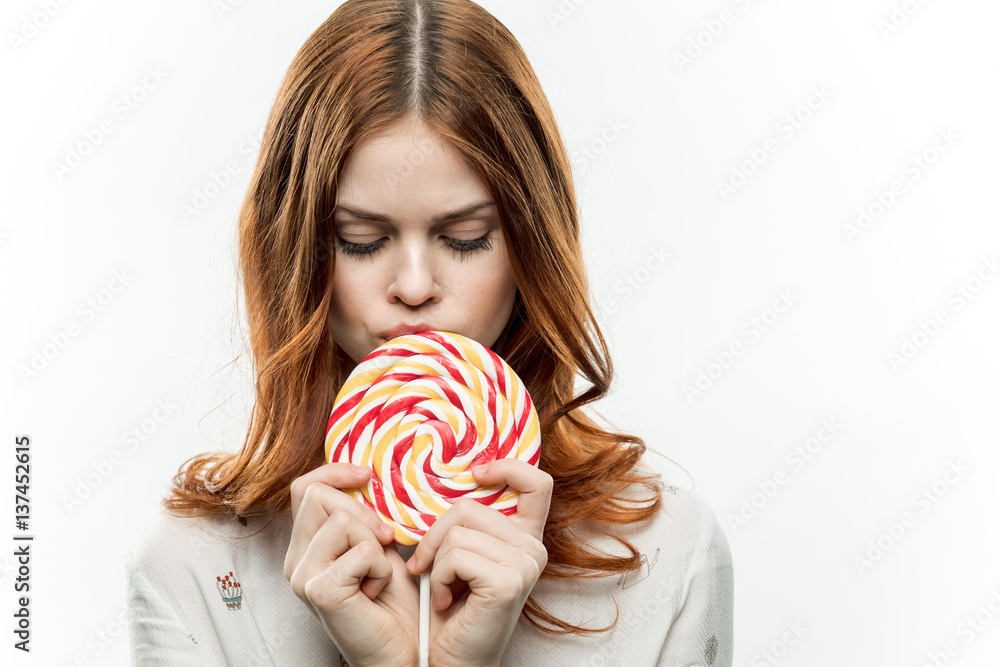 woman kissing round lollipop