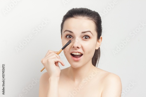 happy woman with makeup brush