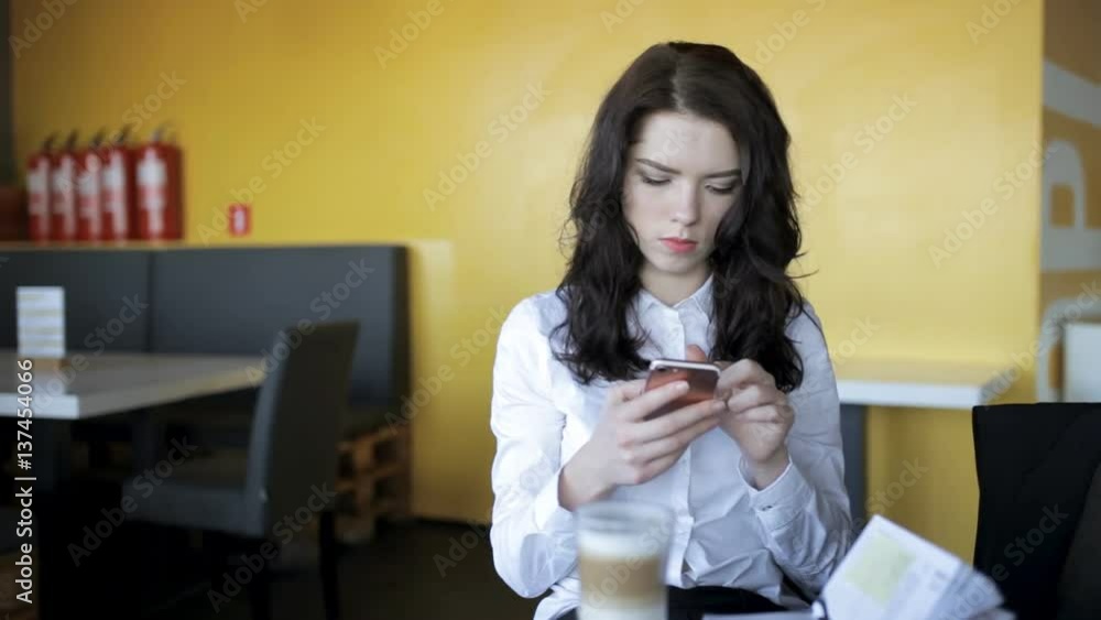 Modern generation. Woman using smartphone in cafe while latte is cools. Modern generation. Woman using smartphone in cafe while latte is cools.