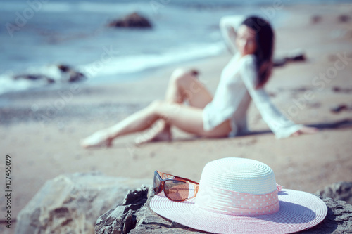 Happy woman enjoying beach relaxing joyful in summer by tropical blue water.