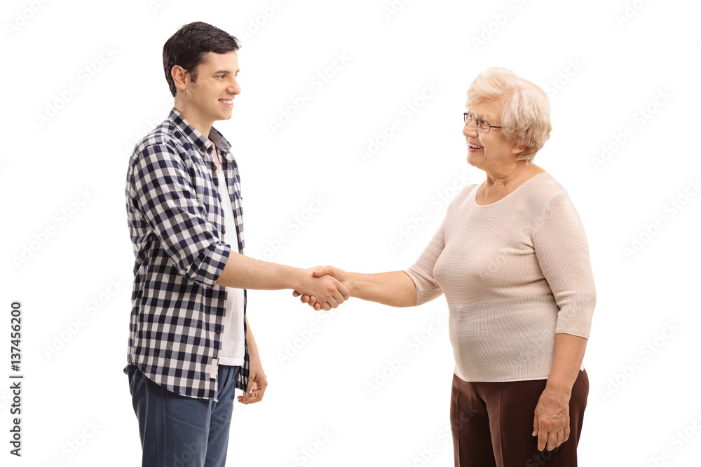 Young man shaking hands with an elderly woman