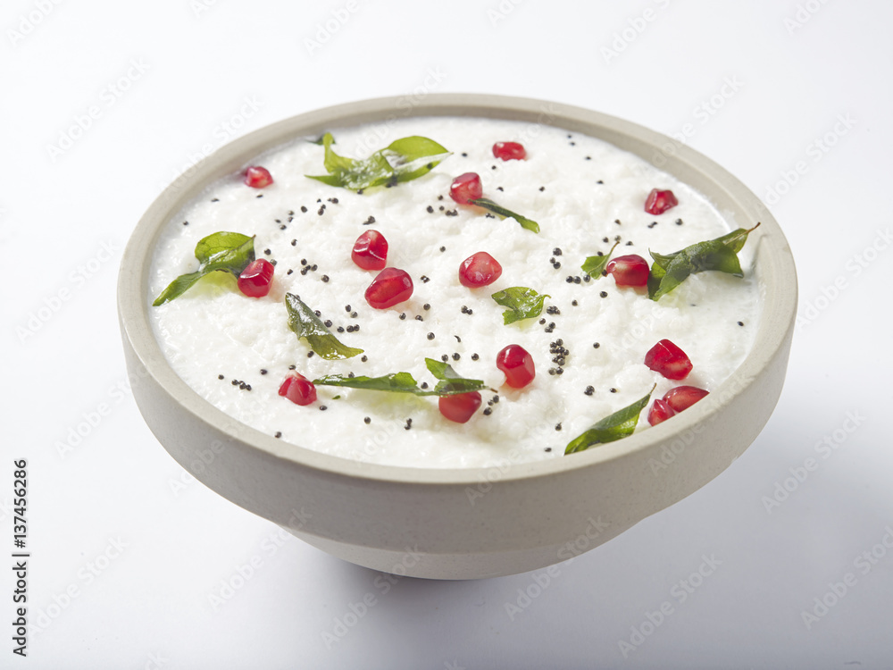 Curd rice in a bowl topped with pomegranate Curd rice in a bowl topped with pomegranate