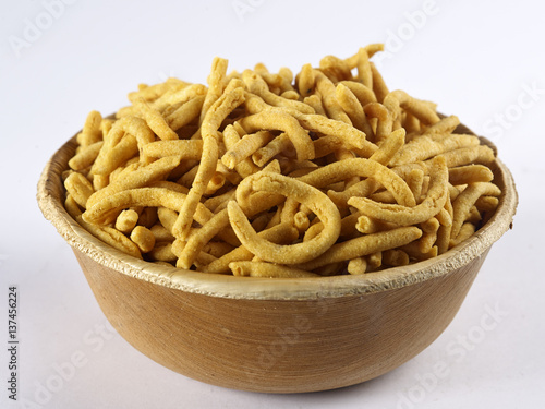Khara sev served in a areca cup on white background
