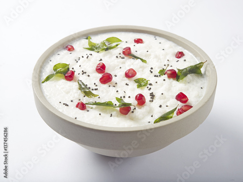 Curd rice in a bowl topped with pomegranate 