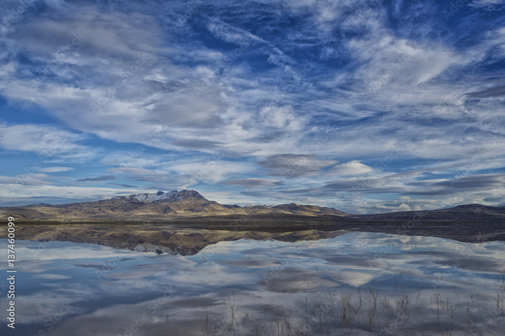 Image of a mountain reflected in a desert dry Lake or Lago Seco filled with water