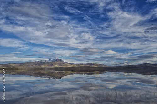 Image of a mountain reflected in a desert dry Lake or Lago Seco filled with water