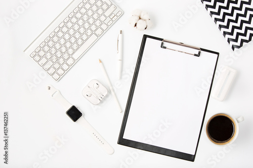 Top view of white office table with notebook