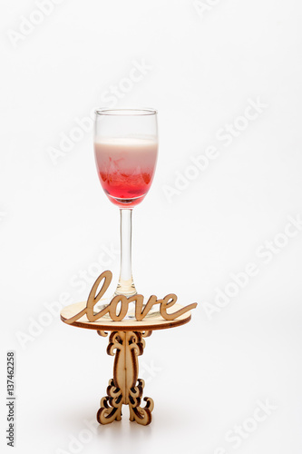 alcohol coctail singapore sling on decorative table with love inscription