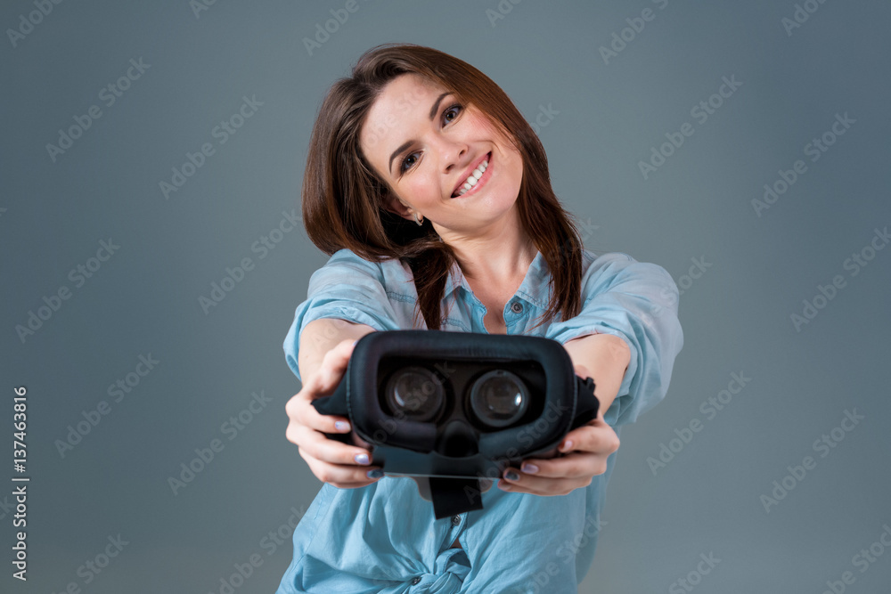 Girl offers to wear glasses virtual reality, VR goggles, VR-headset glasses Girl offers to wear glasses virtual reality, VR goggles, VR-headset glasses
