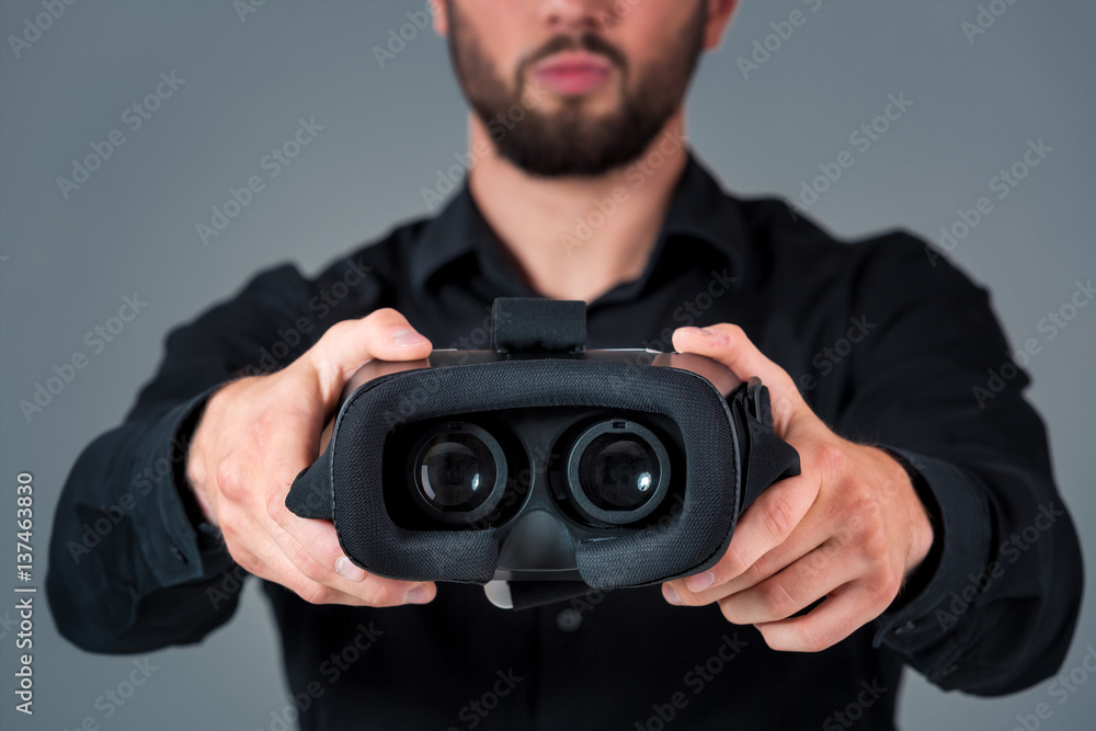Man offers to wear glasses virtual reality, VR goggles, VR-headset glasses Man offers to wear glasses virtual reality, VR goggles, VR-headset glasses