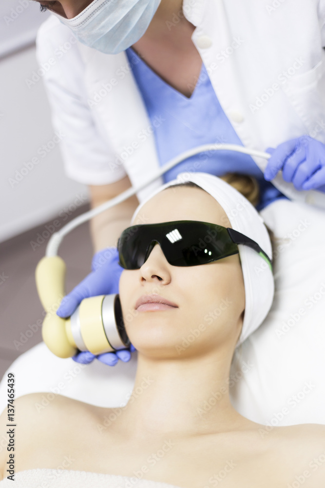 Laser treatment at salon, woman with protective glasses Laser treatment at salon, woman with protective glasses