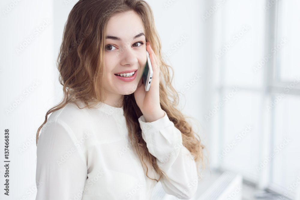 portrait of beautiful young woman with phone by window portrait of beautiful young woman with phone by window