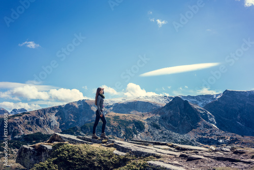 Woman admiring the view hiking the rila mountains photo