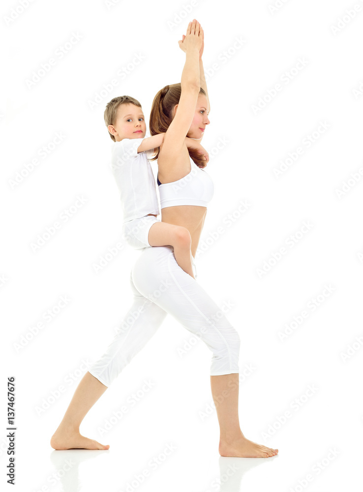 Mother and son doing yoga exercise. Mother and baby gymnastics. Mother and son doing yoga exercise. Mother and baby gymnastics.