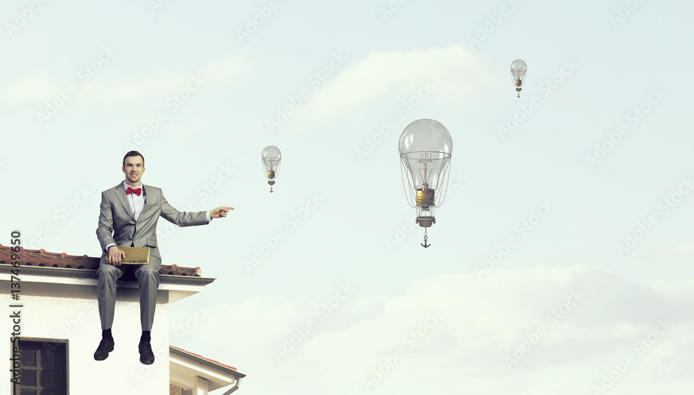 Businessman reading old book . Mixed media Businessman reading old book . Mixed media