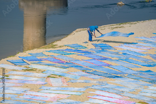 Indian people washing cloth at Yamuna river in Agra, India.