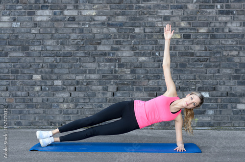 Beautiful woman doing plank abdominal exercises