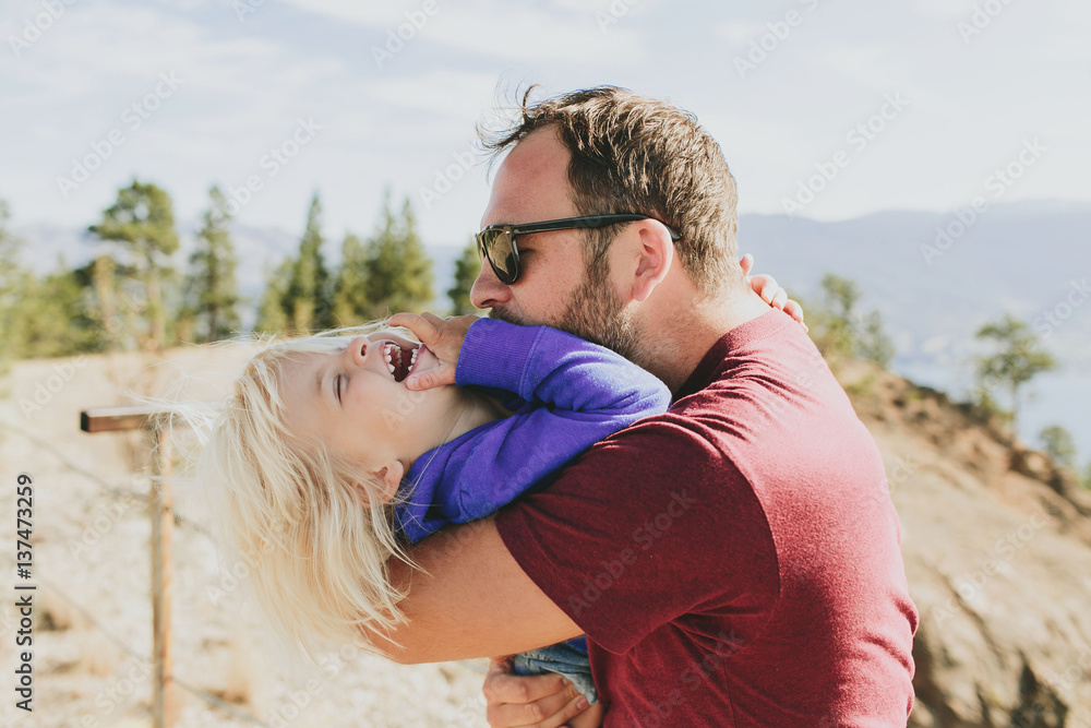 Father hugging daughter, Peachland, British Columbia, Canada Father hugging daughter, Peachland, British Columbia, Canada