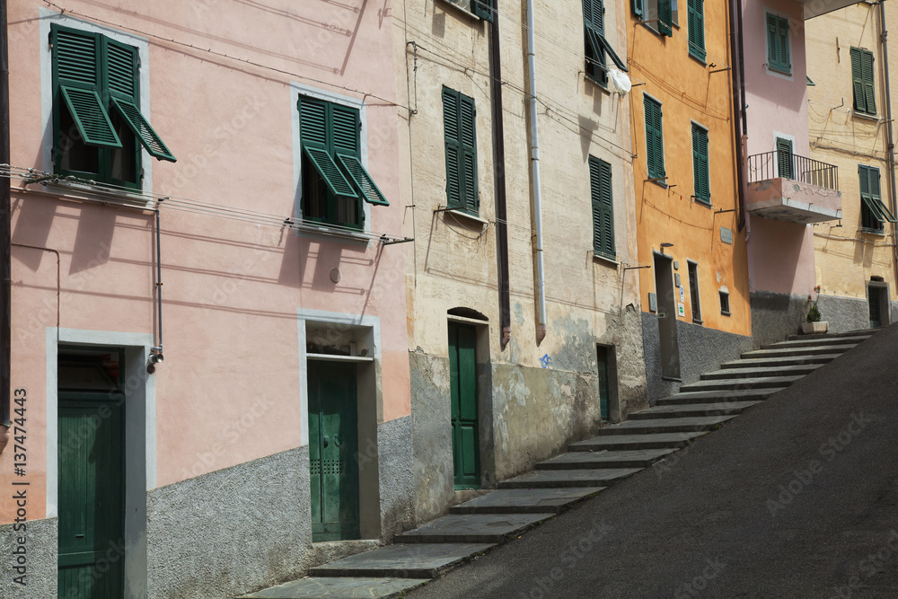 Buildings with green doors and shutters line the street; Riomaggiore, Liguria, Italy Buildings with green doors and shutters line the street; Riomaggiore, Liguria, Italy