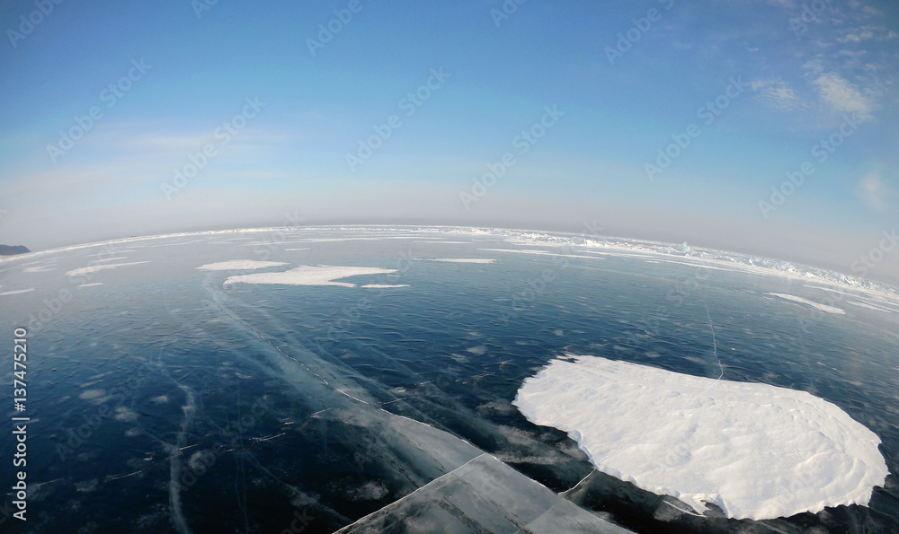 Picture taken by the action camera. Fish-eye lens. Panorama of the frozen ice of Lake Baikal Photo toned Picture taken by the action camera. Fish-eye lens. Panorama of the frozen ice of Lake Baikal Photo toned