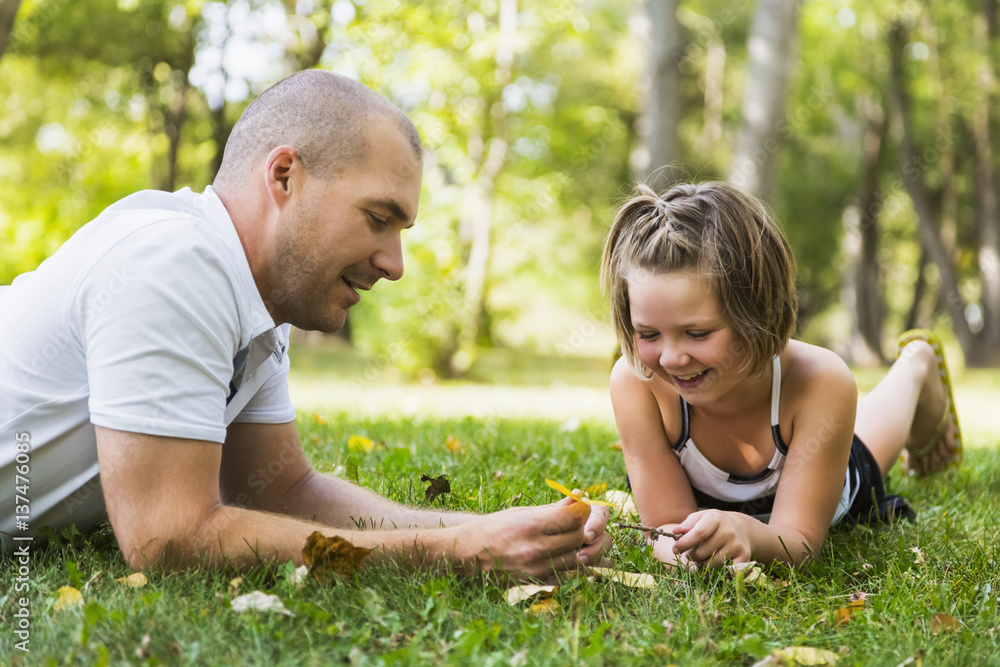 A father spending quality time with his daughter in a park during a family outing; Edmonton, Alberta, Canada A father spending quality time with his daughter in a park during a family outing; Edmonton, Alberta, Canada