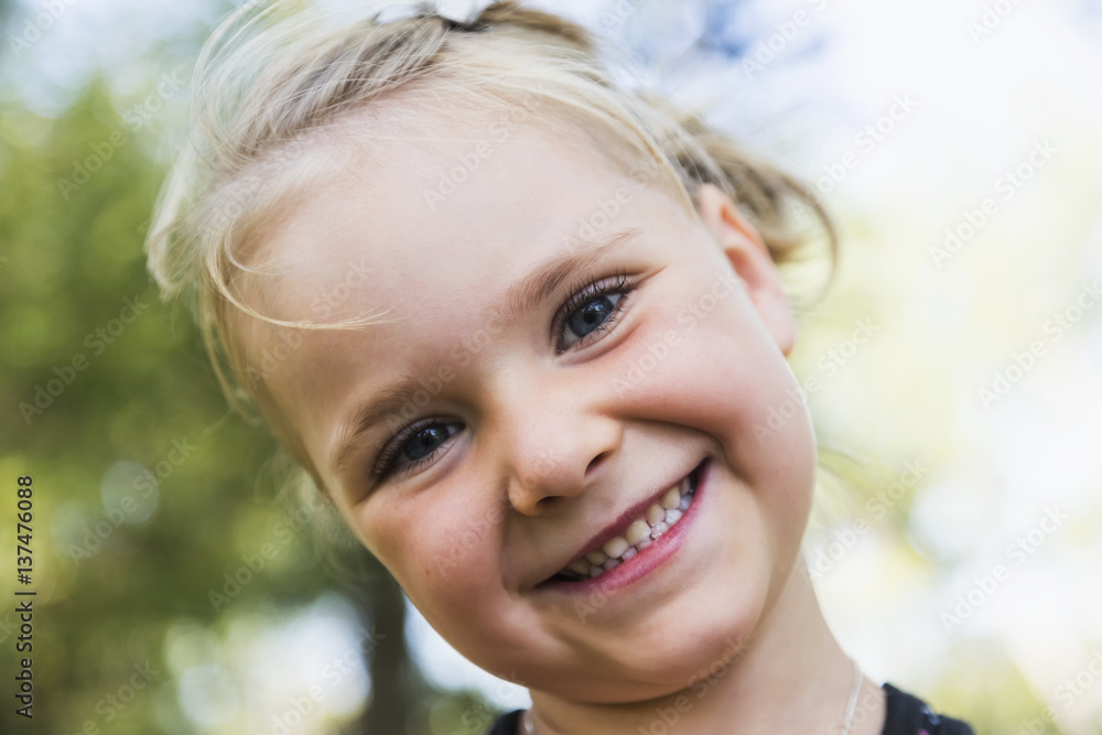 Portrait of a young girl with a big smile and blond hair; Edmonton, Alberta, Canada Portrait of a young girl with a big smile and blond hair; Edmonton, Alberta, Canada