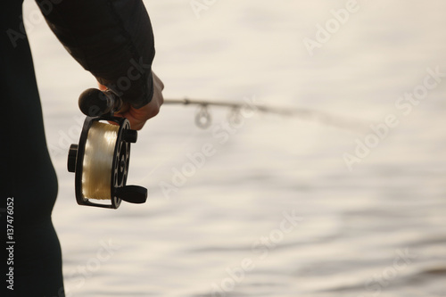 Rod And Reel In Fisherman''S Hand While Salmon Fishing