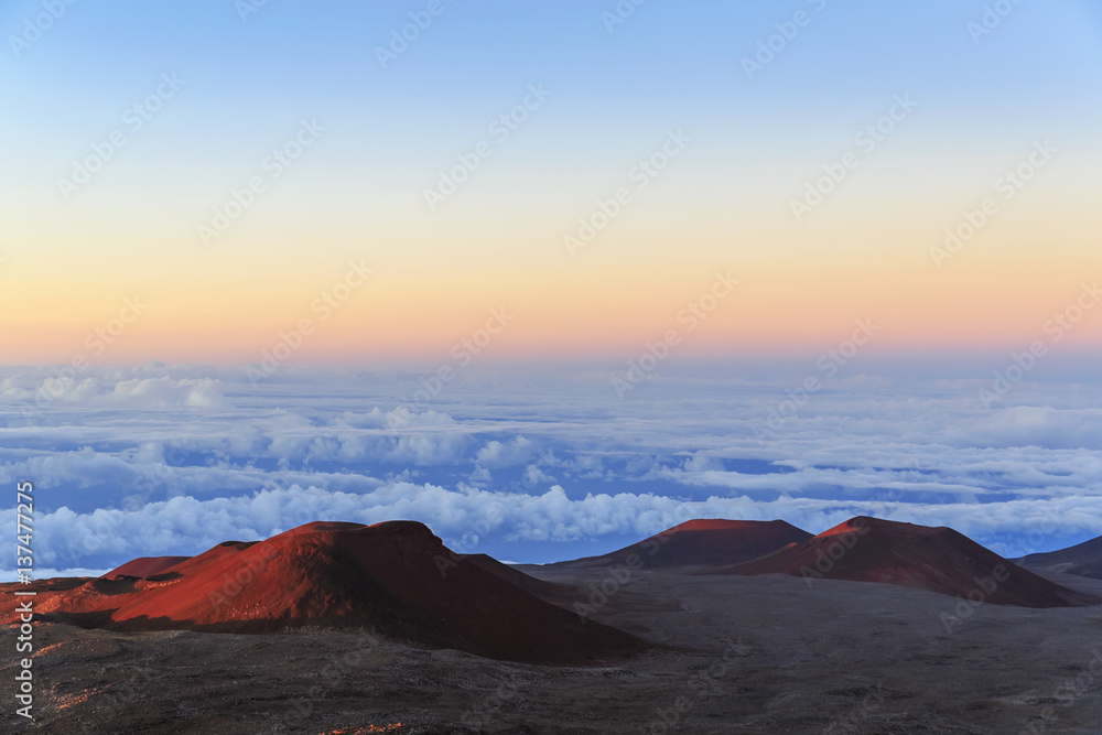 Cinder cones and caldera from ancient lava eruptions atop 4200 meter Mauna Kea, tallest mountain in Hawaii, at sunset; Island of Hawaii, Hawaii, United States of America Cinder cones and caldera from ancient lava eruptions atop 4200 meter Mauna Kea, tallest mountain in Hawaii, at sunset; Island of Hawaii, Hawaii, United States of America