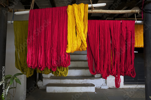 Colourful recently dyed thread hanging out to dry at weavers