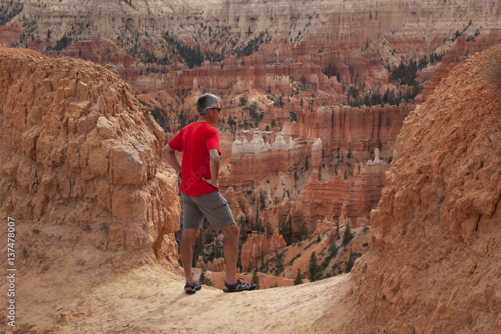 A senior man hikes overlooking Bryce Canyon National Park; Utah, United States