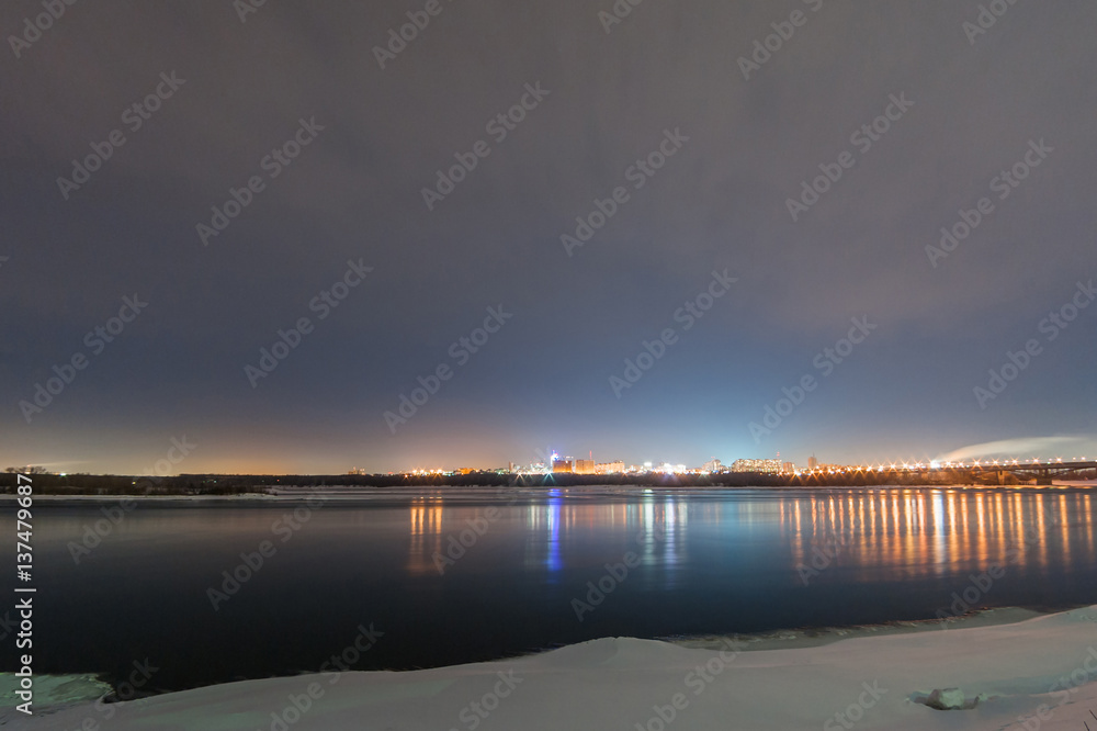 view of the river and city at night in winter