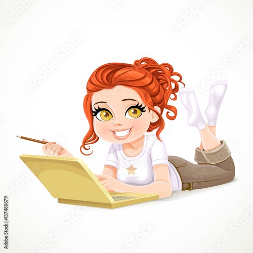 Beautiful redhaired girl lying on a white floor and working at a laptop