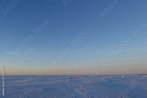 White snow desert of the Gulf of Finland morning before dawn