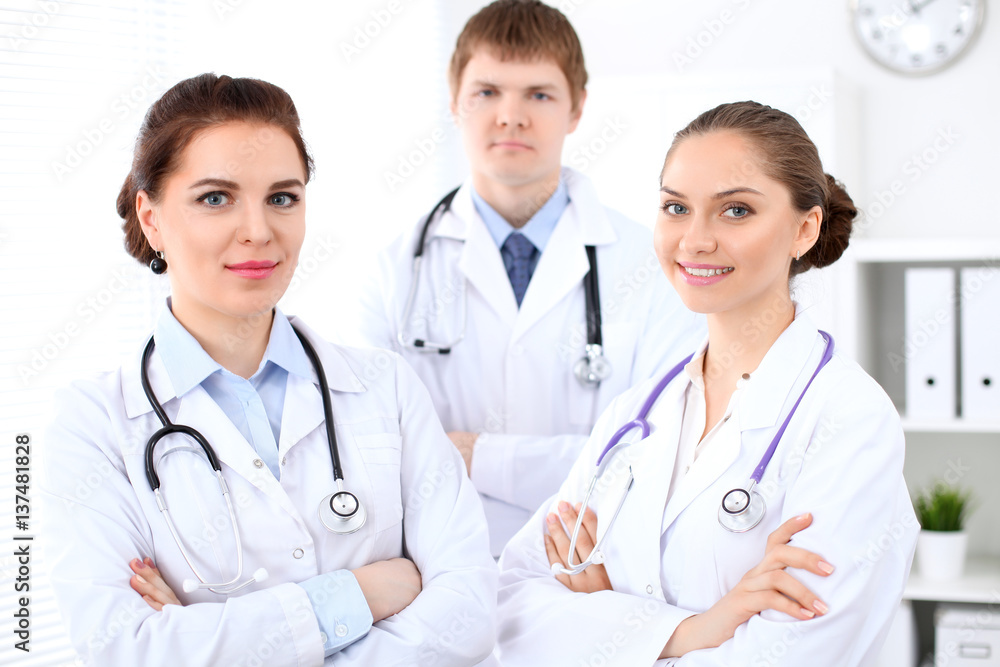 Happy female doctor with medical staff at the hospital. Successful team at health care concept Happy female doctor with medical staff at the hospital. Successful team at health care concept