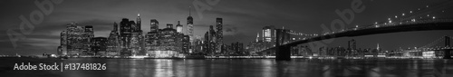 New York city with Brooklyn Bridge, iconic skyline panorama at night in black and white © andersphoto