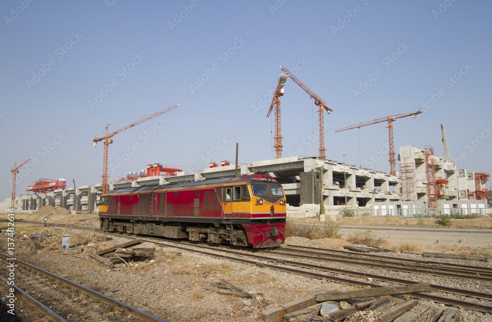 Old diesel engine on railways track with construction in background Old diesel engine on railways track with construction in background