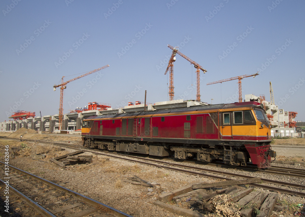 Old diesel engine on railways track with construction in background Old diesel engine on railways track with construction in background