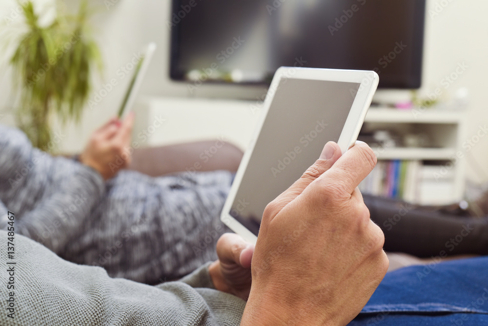man and woman using electronic devices man and woman using electronic devices