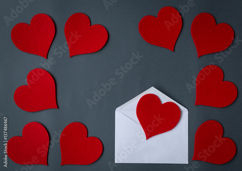 Love letter envelope with red hearts on gray background