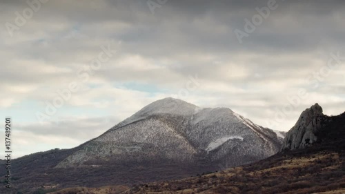 Clouds fly over snowy mountain peak