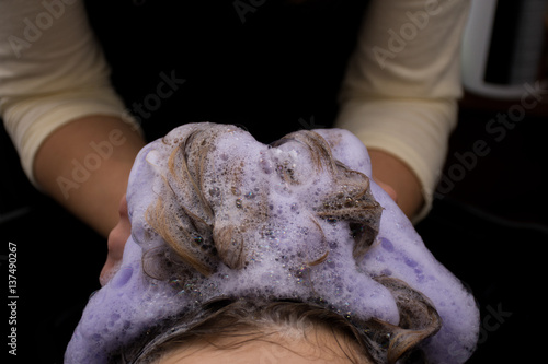 Hairdresser washing a clients hair