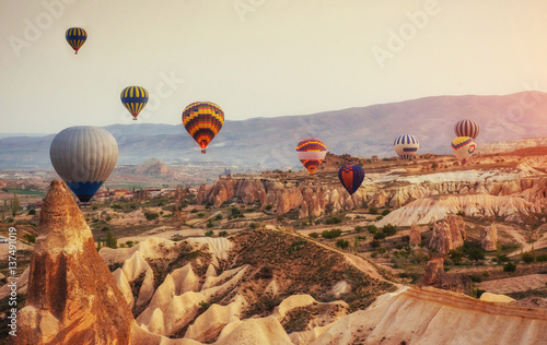 Hot air balloon flying over rock landscape at Turkey. Cappadocia © standret