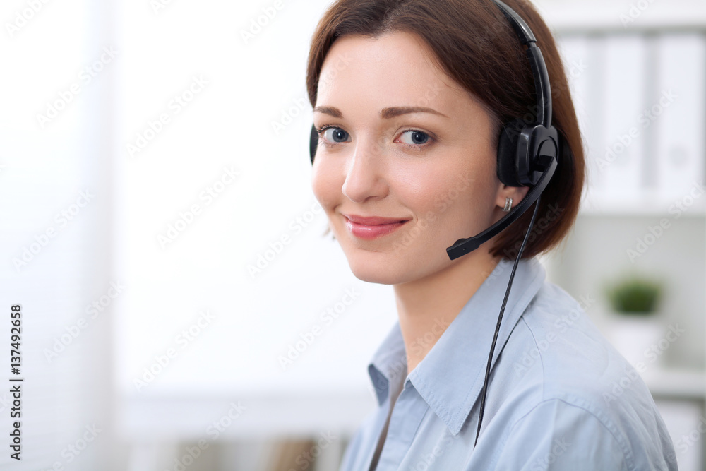 Young beautiful business woman in headset. Call center. Young beautiful business woman in headset. Call center.