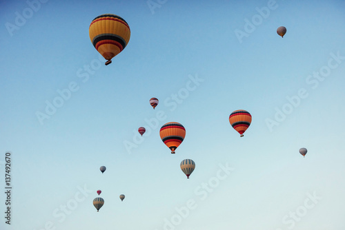 group of colorful hot air balloons against a blue sky