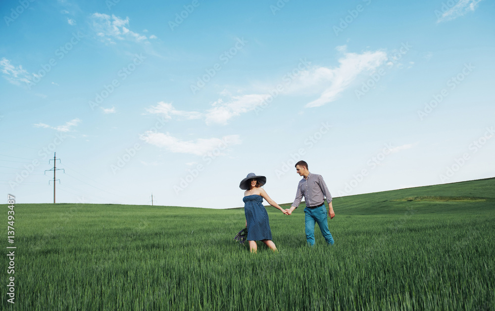 Happy family hugging in a field of green wheat Happy family hugging in a field of green wheat