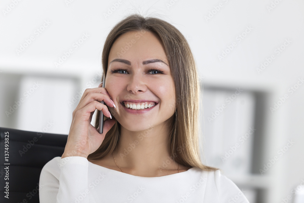 Front view of woman with a smartphone in office Front view of woman with a smartphone in office