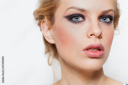 Pretty blonde girl closeup portrait with smokey eyes