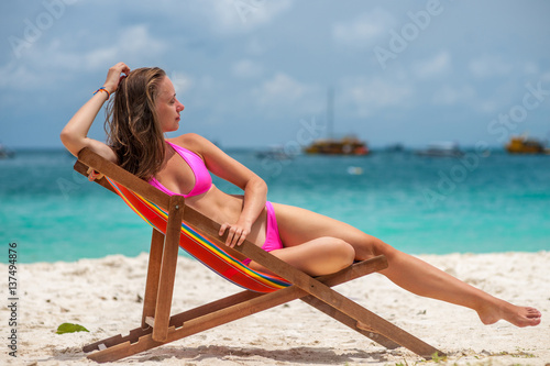 Woman in lounger on tropical beach