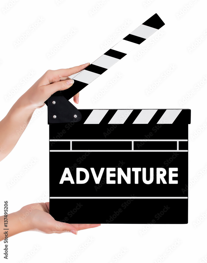 Hands holding a clapper board with ADVENTURE text